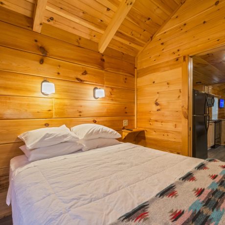 Hullabaloo Cabin bedroom at Great Escapes RV Resorts Bryan College Station