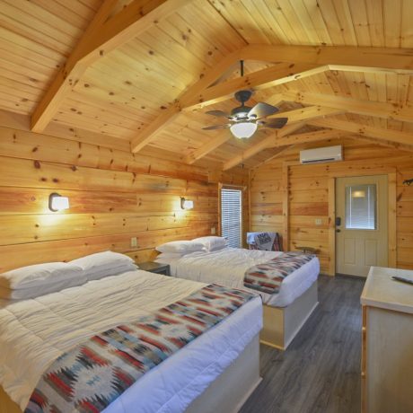 furnished bedroom in family camping cabin at Great Escapes RV Resorts Bryan College Station