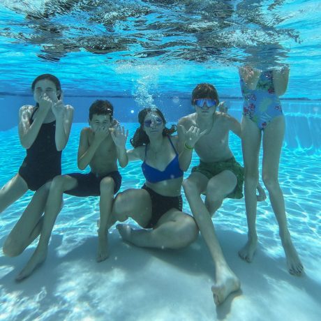 kids underwater at the pool at Great Escapes RV Park Campground Resort in Bryan College Station near Aggieland