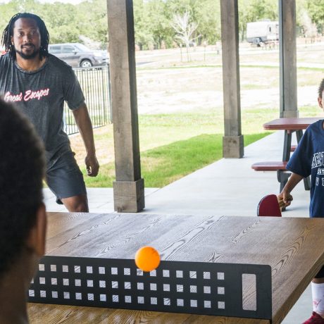 family playing ping pong at Great Escapes RV Resorts Bryan College Station