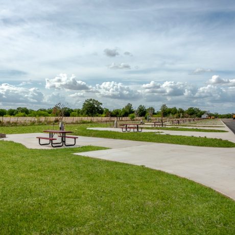 empty RV site with concrete pad and picnic table at Great Escapes RV Resorts Bryan College Station