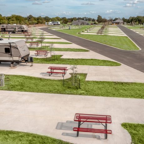 lineup of RV sites with concrete pads and picnic tables at Great Escapes RV Resorts Bryan College Station
