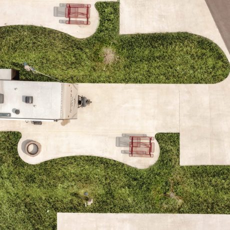 aerial view of RV site with concrete pad and picnic table at Great Escapes RV Resorts Bryan College Station